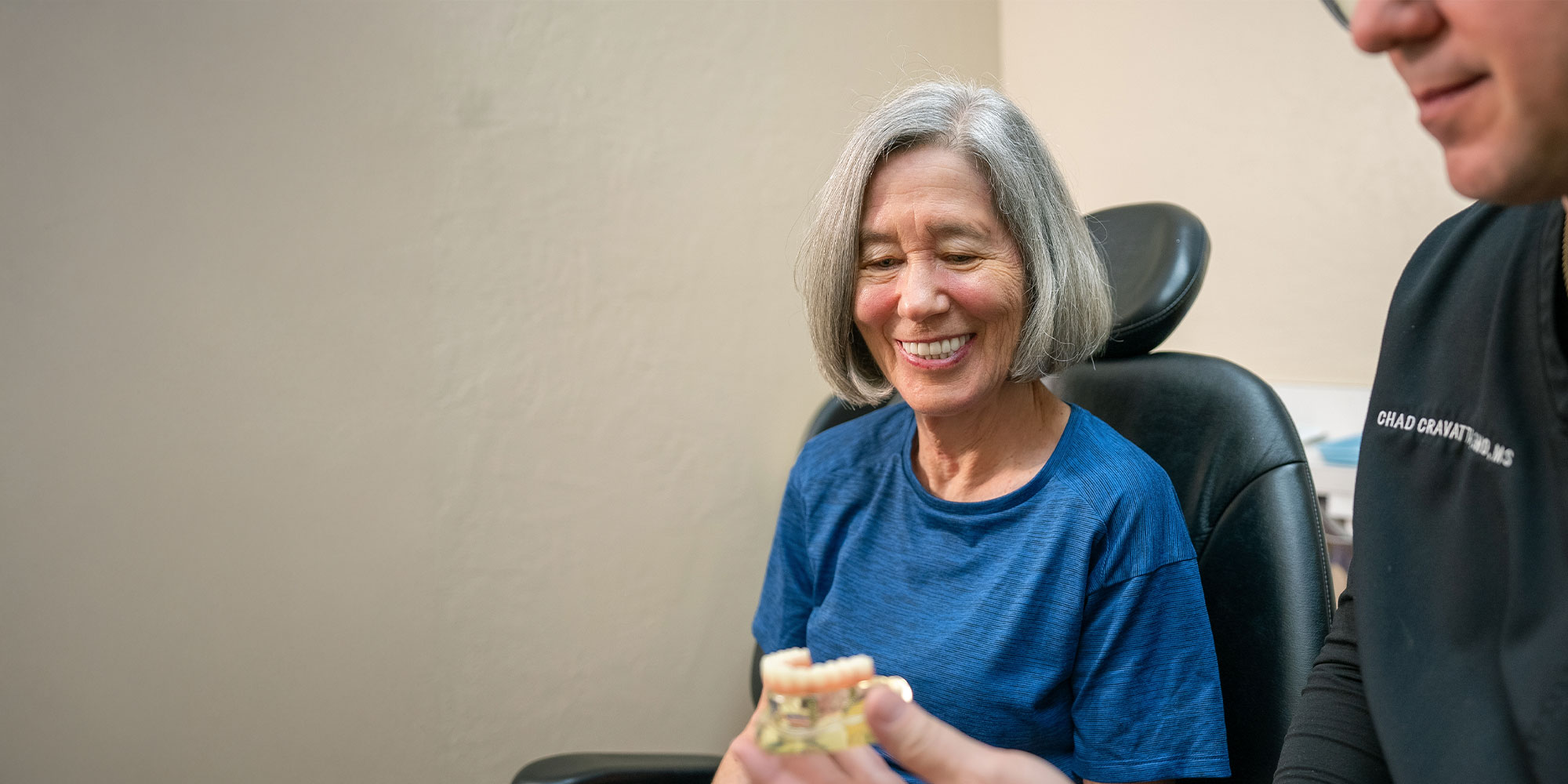 dr cravatta showing real full arch implant model